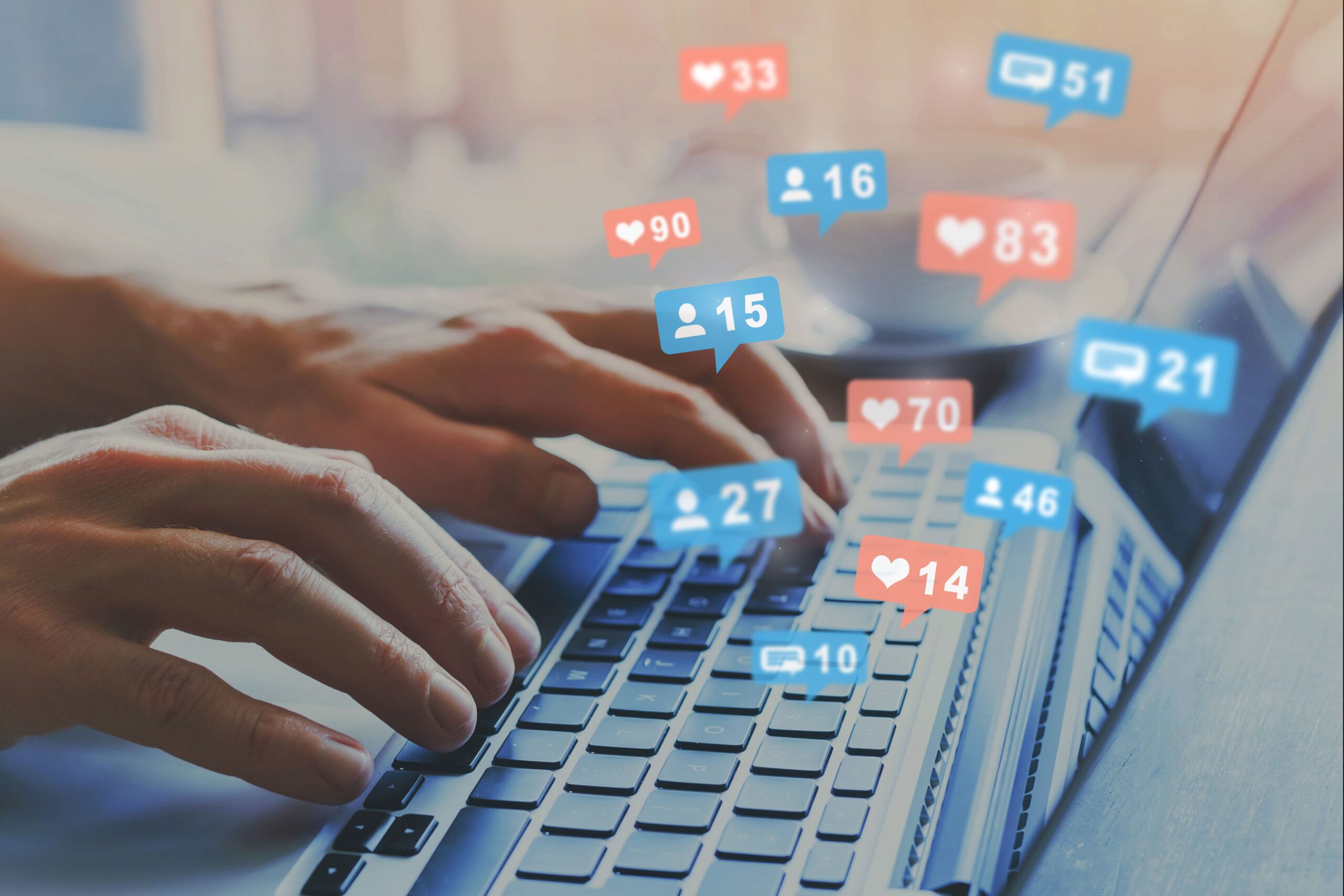 Onlyfans Management Company enabling creators to grow engagement without burnout, illustrated by social media notifications over hands on keyboard